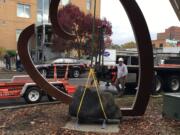 A crane lowers the steel and basalt &quot;Heart and Stone&quot; sculpture into place Thursday at Sixth Street and Columbia Street in downtown Vancouver.