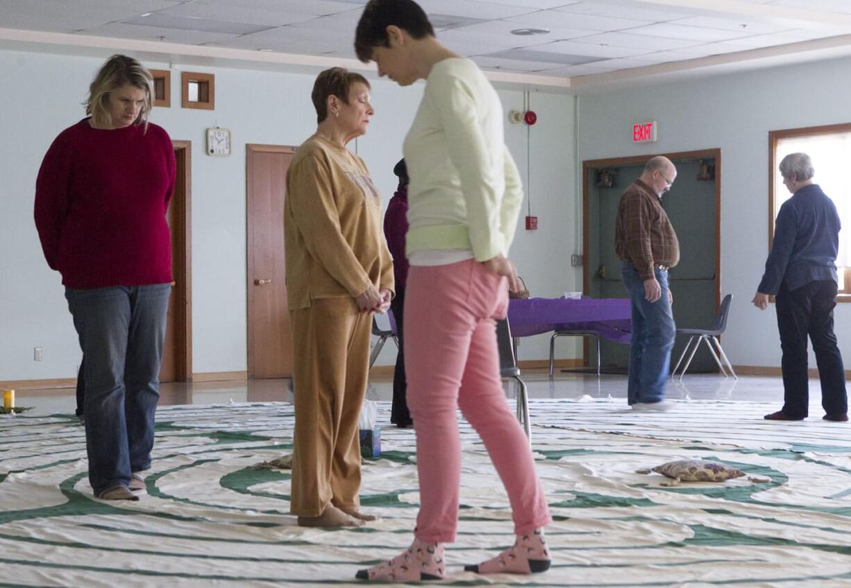 Participants walk through a canvas labyrinth at First Presbyterian Church in Vancouver on New Year's Day.