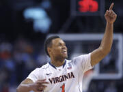 Virginia guard Justin Anderson points to the crowd in celebration. Virginia is among four No.