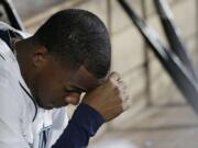 Seattle Mariners starting pitcher Roenis Elias sits in the dugout after being pulled from a baseball game against the Oakland Athletics in the third inning, Saturday, Oct. 3, 2015, in Seattle. (AP Photo/Ted S.