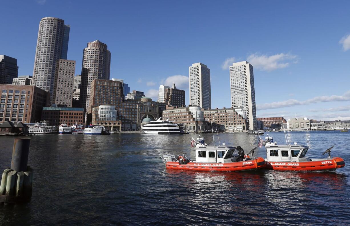 U.S. Coast Guard boats patrol the Boston Harbor outside the federal courthouse, Monday, Jan. 5, 2015, in Boston, during the first day of jury selection in the trial of Boston Marathon bombing suspect Dzhokhar Tsarnaev.