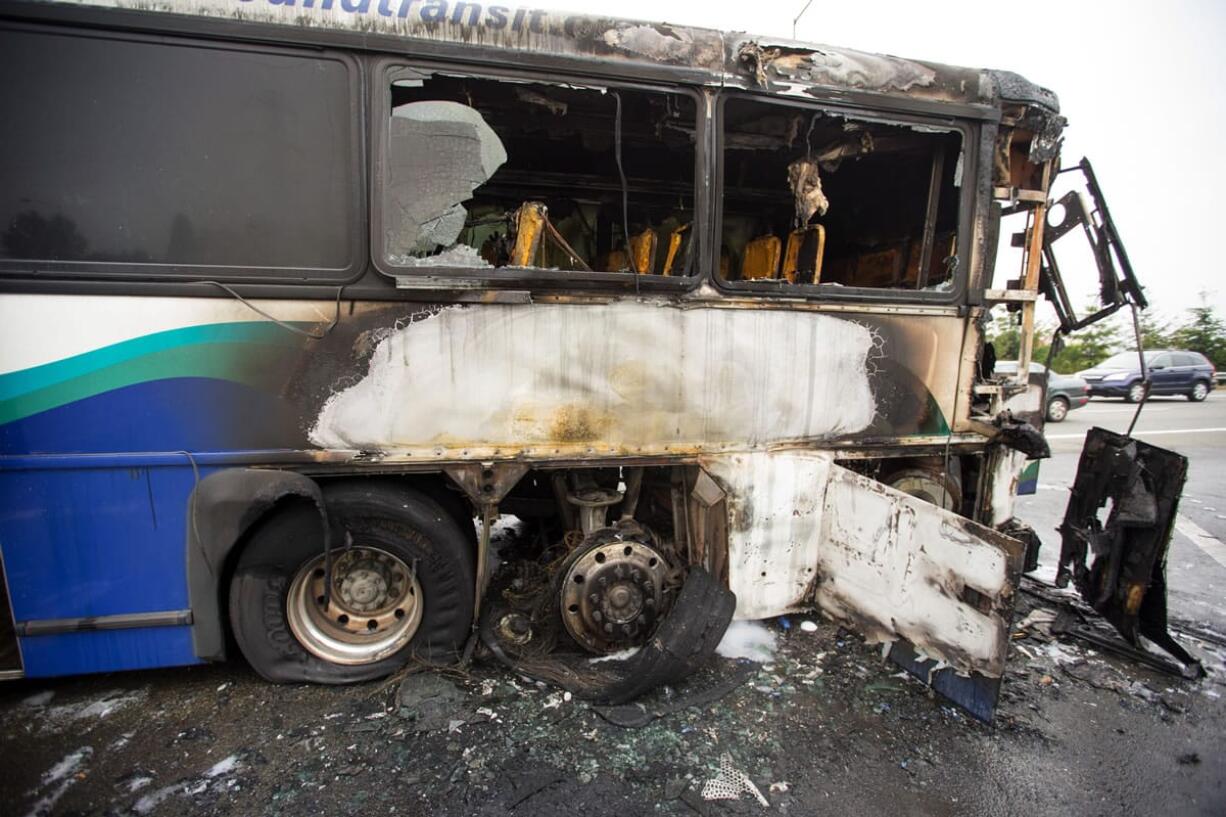 The charred remains of a Sound Transit bus rests on the shoulder of northbound Interstate 405 on Wednesday near Interstate 90 near Bellevue. A quick thinking bus driver ensured that none of the 30 passengers were injured when the vehicle caught fire early Wednesday while heading north on Interstate 405, officials said.