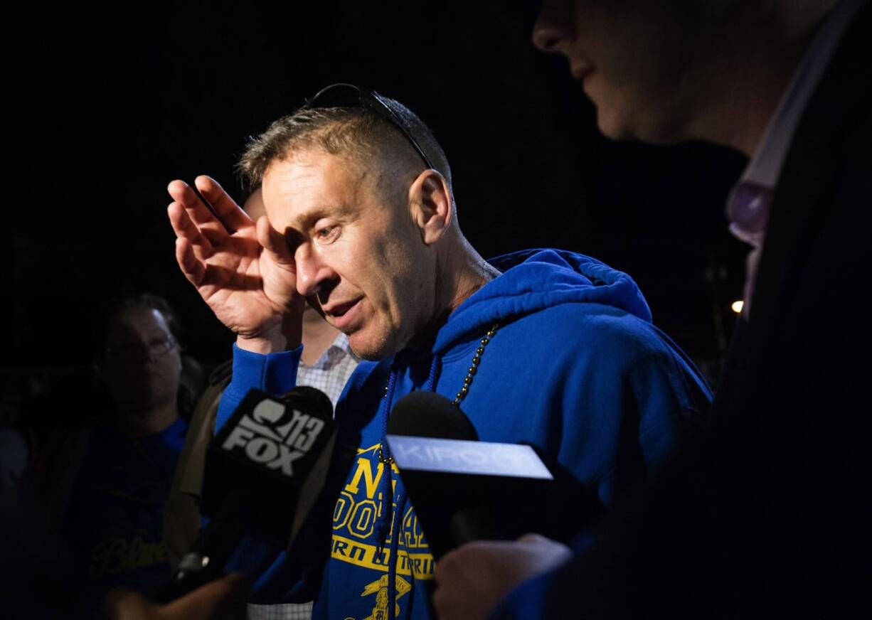 Bremerton High assistant football coach Joe Kennedy wipes his eyes as he talks to the media after a football game earlier this month in Bremerton  (Lindsey Wasson /The Seattle Times via AP)