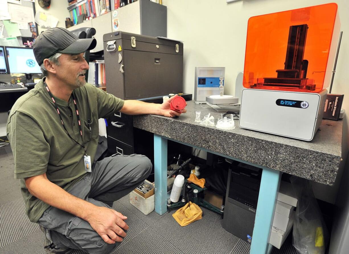 Stephen Foster, department chair of Manufacturing and Engineering with the Rogue Community College Table Rock Campus in White City Ore., shows a functioning fly reel that he made on the school&#039;s new 3-D printer.