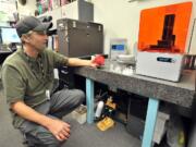 Stephen Foster, department chair of Manufacturing and Engineering with the Rogue Community College Table Rock Campus in White City Ore., shows a functioning fly reel that he made on the school&#039;s new 3-D printer.