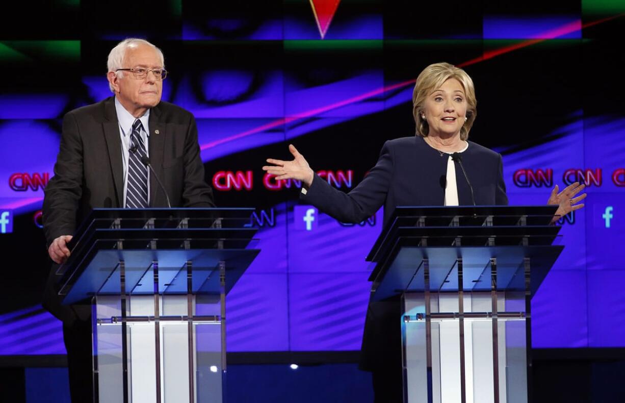 Hillary Rodham Clinton, right, speaks as Sen. Bernie Sanders, of Vermont, looks on during the CNN Democratic presidential debate Tuesday in Las Vegas.