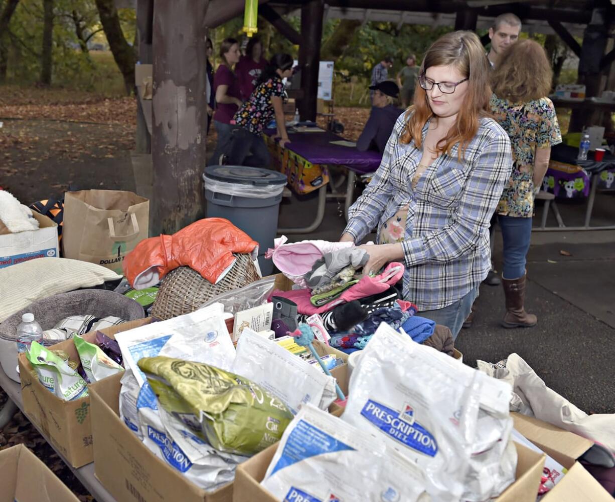 Volunteer Zoey Schwartz organizes pet supplies to be handed out in Corvallis, Ore., for pets whose owners&#039; budgets are deeply limited.