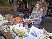 Volunteer Zoey Schwartz organizes pet supplies to be handed out in Corvallis, Ore., for pets whose owners&#039; budgets are deeply limited.
