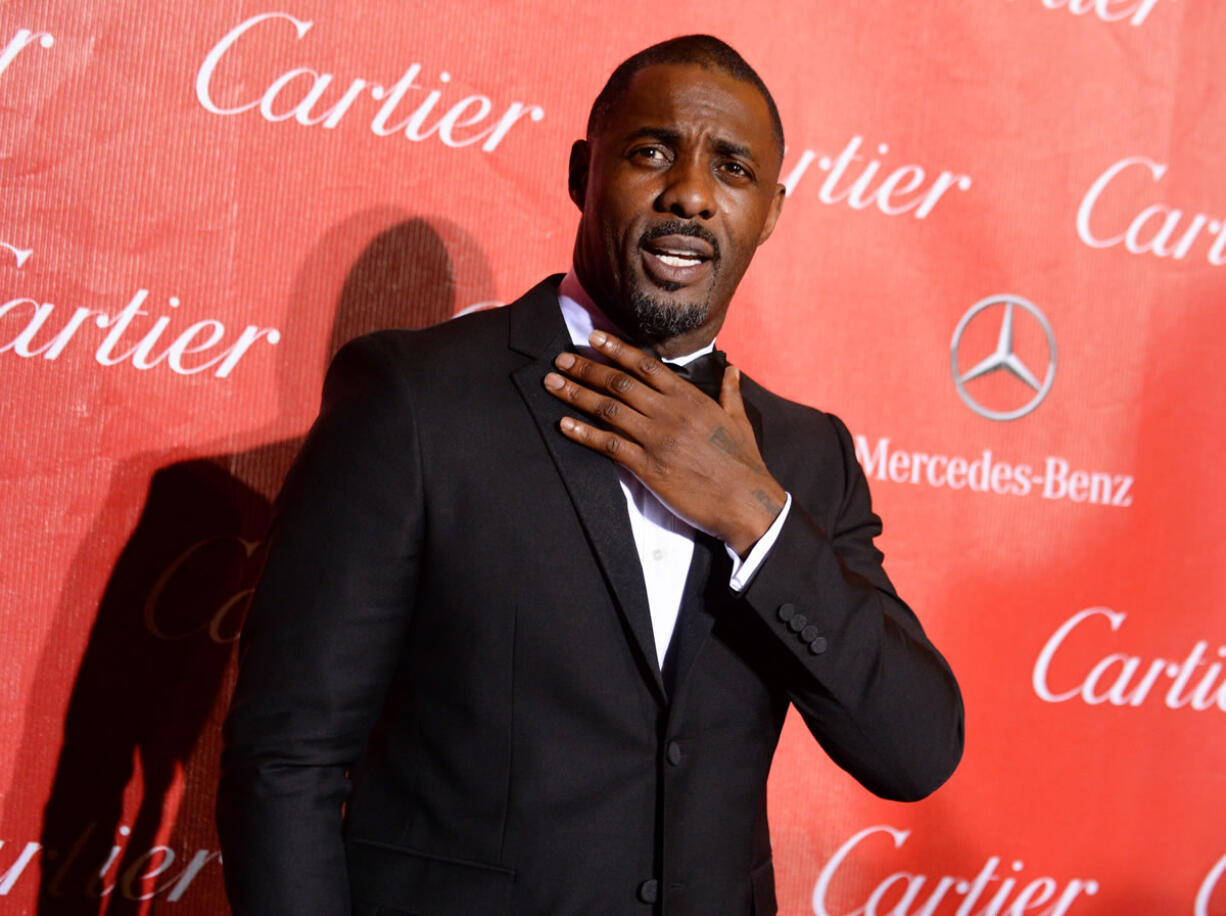 Idris Elba arrives Jan. 4, 2014 at the Palm Springs International Film Festival Awards Gala in Palm Springs, Calif. The spring exhibition at the Metropolitan Museum of Art&#039;s Costume Institute will focus on technology&#039;s impact on fashion, and the May 2 gala benefiting the institute will be co-chaired by Elba, Apple&#039;s chief design officer, Jonathan Ive, Taylor Swift and Anna Wintour.