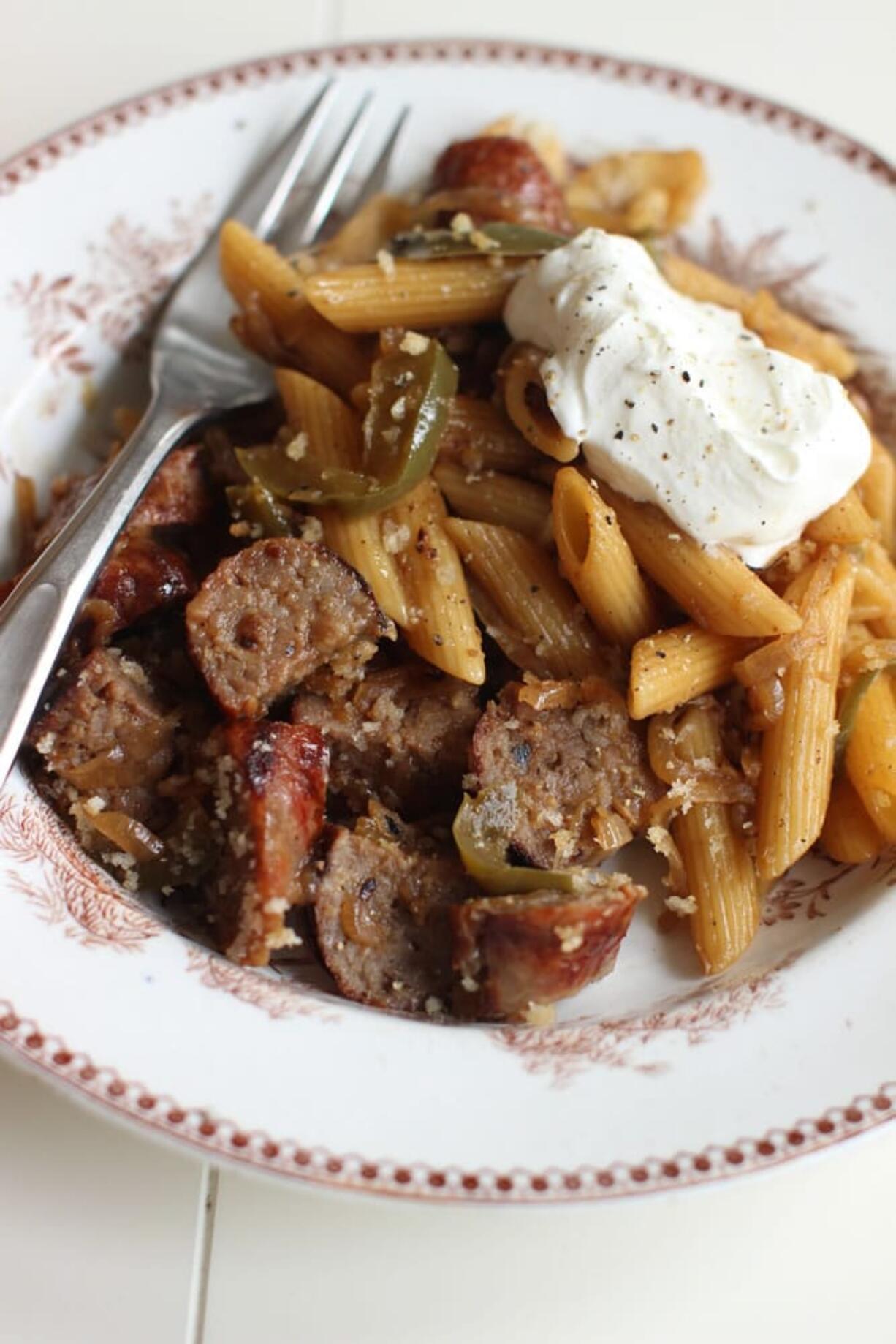 Bratwurst pasta bake with caramelized onions, peppers and apples.