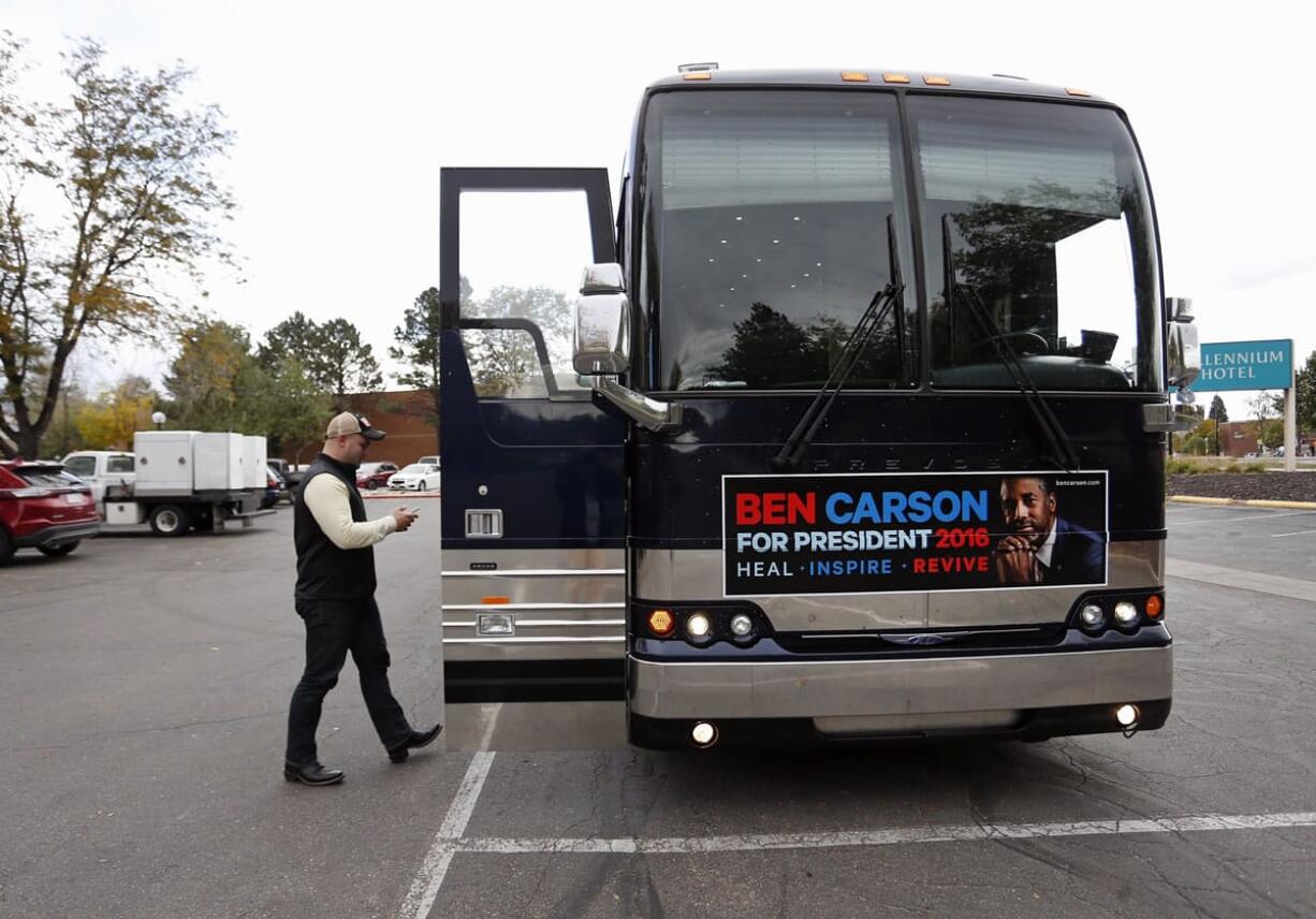 Matthew Posey, the national field manager for Ben Carson&#039;s presidential campaign, texts while walking into the Carson campaign bus, a day before Carson is to participate in the CNBC Republican presidential debate in Boulder, Colo., on Tuesday.