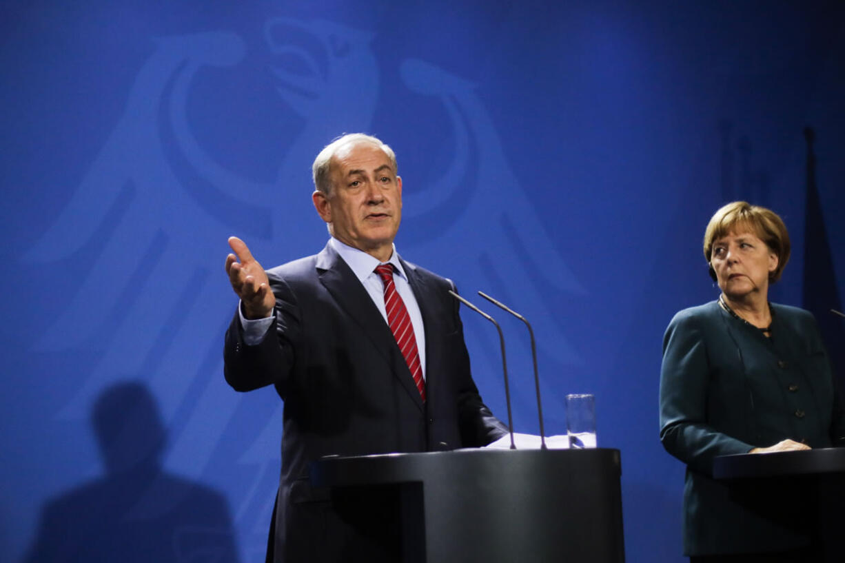 German Chancellor Angela Merkel, right, and Israeli Prime Minister Benjamin Netanyahu brief the media during a meeting at the chancellery in Berlin, Wednesday, Oct. 21, 2015.