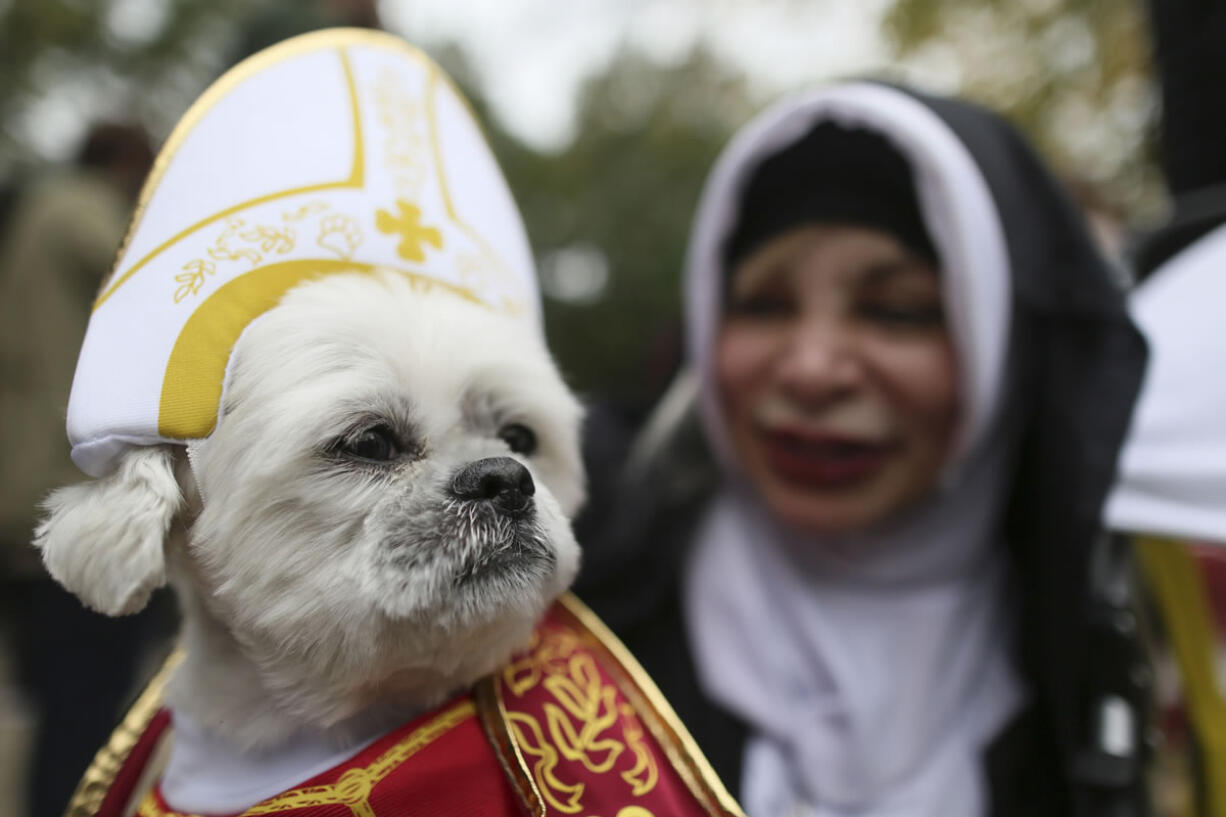 Michelle Guillen and her shih tzu, Jojo, wear a pope and a nun costume for the Tompkins Square Halloween Dog Parade.