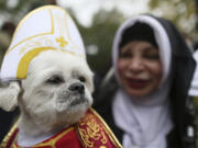 Michelle Guillen and her shih tzu, Jojo, wear a pope and a nun costume for the Tompkins Square Halloween Dog Parade.