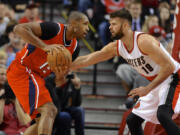 Atlanta Hawks' Al Horford (15) works against Portland Trail Blazers' Joel Freeland (19) during the first half on Saturday, Jan.