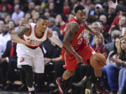 Atlanta's Jeff Teague, right, and Portland's Damian Lillard give chase to the ball during the first half Saturday.