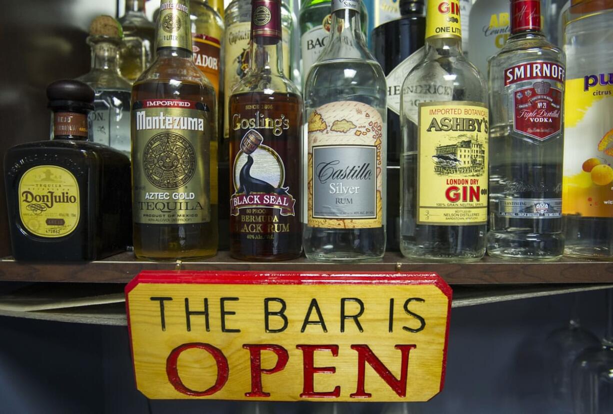 Alcohol bottles, their contents replaced with colored water, sit on a shelf in the National Institute on Alcohol Abuse and Alcoholism's research alcohol bar Dec.