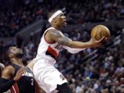 Portland's Damian Lillard, right, drives to the basket past Miami's Dwyane Wade during the second half Thursday.