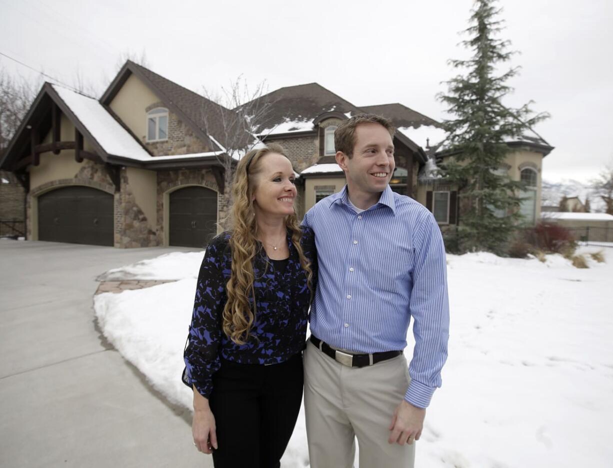 Jeff Bennion and his wife Tanya stand in front of their home Monday, Jan. 5, 2015, near Salt Lake City. Two Utah men set to appear in the reality TV show ?My Husband?s Not Gay,? say they?re fulfilled in their relationships to their wives even though they?re attracted to other men. The show?s concept has come under fire since it was announced by the TLC network last month.