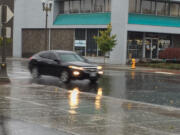 A car speeds down West Eighth Street in Vancouver during Saturday's rainstorm.