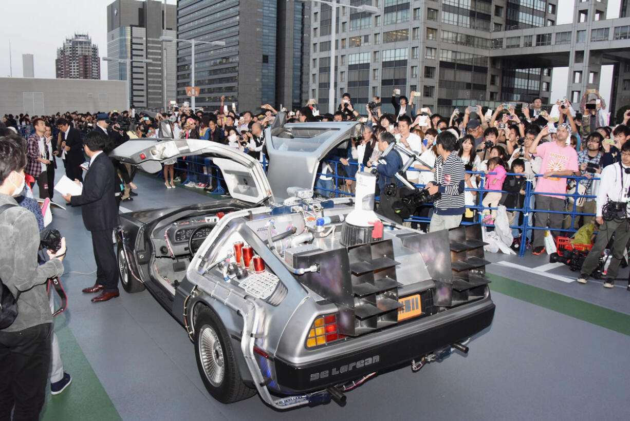 A DeLorean, remodeled similar to the "Back to the Future Part II" time machine, that runs on bioethanol fuel made from garbage, is shown to fans during a special celebration event organized by NBC Universal Entertainment Japan to mark the 30th anniversary of the sci-fi film's debut, in Tokyo on  Wednesday.