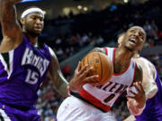 Portland Trail Blazers guard Damian Lillard, right, is fouled by Sacramento Kings center DeMarcus Cousins during the second half of an NBA  preseason game in Portland on Monday, Oct. 5, 2015.