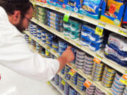 Orthodox Jewish rabbi Dovid Lepkivker looks through cans of tuna in a grocery store in Helena, Mont. Lepkivker and fellow rabbi Eli Chaikin are on a mission to reach as many Montana Jews as they can to teach them how to keep kosher.