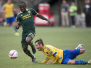 Colorado Rapids midfielder Marcelo Sarvas, right, falls to the turf as he is defended by Portland Timbers Diego Chara, left, during the first half of their MLS soccer game in Portland, Ore., Sunday, Oct. 25, 2015.