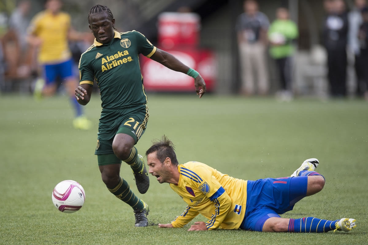 Colorado Rapids midfielder Marcelo Sarvas, right, falls to the turf as he is defended by Portland Timbers Diego Chara, left, during the first half of their MLS soccer game in Portland, Ore., Sunday, Oct. 25, 2015.