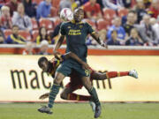 Real Salt Lake&#039;s Aaron Maund falls as he defends Portland  forward Fanendo Adi (9) during the second half Wednesday in Sandy, Utah. The Timbers won 1-0.