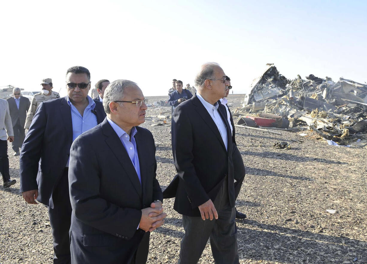 In this image released by the Prime Minister&#039;s office, Sherif Ismail, center, visits the site where a plane crashed in Hassana Egypt, Friday, Oct. 31, 2015. A Russian aircraft carrying 224 people, including 17 children, crashed Saturday in a remote mountainous region in the Sinai Peninsula about 20 minutes after taking off from a Red Sea resort popular with Russian tourists, the Egyptian government said.