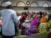 Imam Suleimaan Hamed, left, speaks to members of the Atlanta Masjid of Al Islam mosque in Atlanta. Members of the mosque gathered to celebrate a group of pilgrims who will make the annual Hajj pilgrimage to the holy city of Mecca.