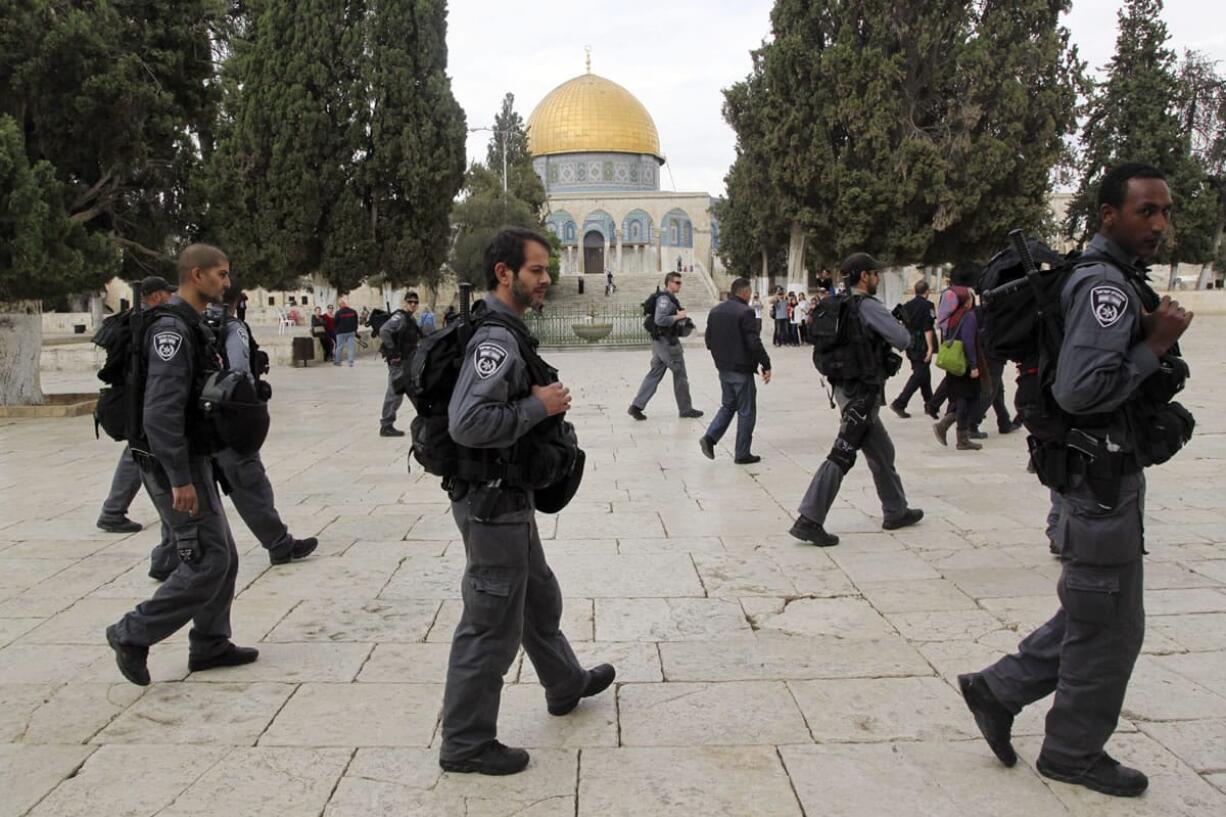 Israeli policeman escort Jewish visitors as they walk past the Dome of the Rock mosque in Jerusalem&#039;s most sensitive holy site, a hilltop compound in the Old City that is revered by Jews and Muslims on Tuesday. Israeli and Jordanian officials said Tuesday that new surveillance cameras should be installed at the walled Jerusalem shrine at the epicenter of Israel-Palestinian violence within days, with the goal of streaming the footage live on the Internet for maximum transparency.