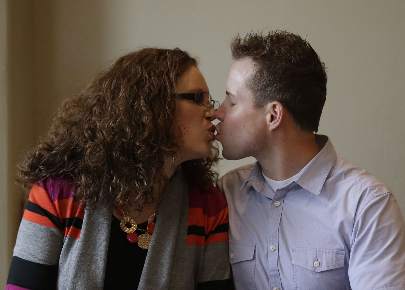 Preston &quot;Pret&quot; and Megan Dahlgren kiss during an interview  Jan. 5 near Salt Lake City. Two Utah men set to appear in the reality TV show &quot;My Husband's Not Gay,&quot; say they're fulfilled in their relationships to their wives even though they're attracted to other men.