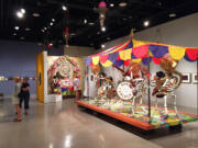 Visitors at &quot;Banda Calaca,&quot; an installation themed on the Day of the Dead at the Tucson Museum of Art, located in the historic downtown Presidio neighborhood in Tucson, Ariz. The exhibition includes a large-scale skeleton band marching toward a memorial altar. Tucson is known for its Day of the Dead celebration, the All Souls Procession, which typically attracts 100,000 people. (Beth J. Harpaz/Associated Press) (Beth J.