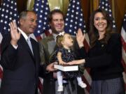 House Speaker John Boehner of Ohio, left, stands Tuesday with Rep.