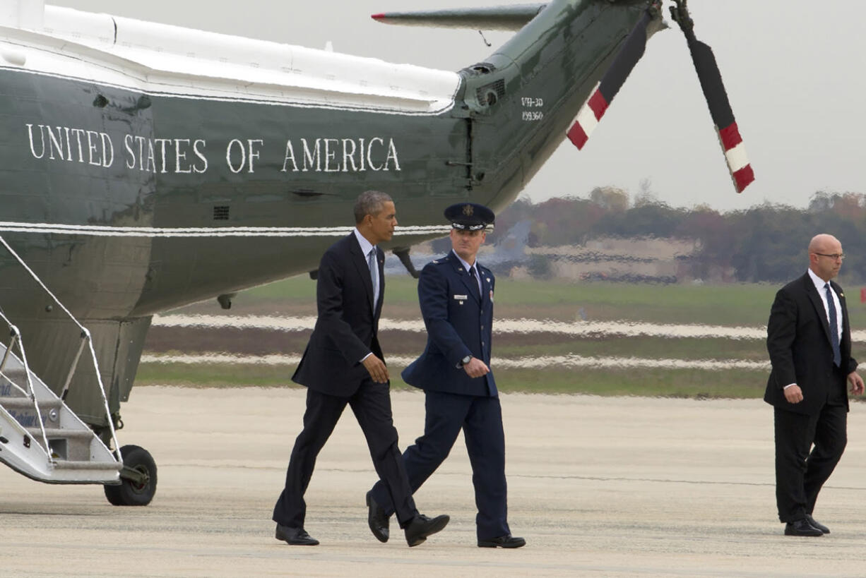 President Barack Obama, accompanied by Vice Commander, of the 89th Airlift Wing Colonel Christopher M. Thompson, walks towards Air Force One before is departure from Andrews Air Force Base, Md., on Tuesday. Obama is traveling to Chicago to speak at the International Association of Chief of Police conference and attend democratic fundraisers.