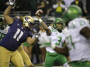 Oregon quarterback Vernon Adams Jr. (3) passes as Washington's Elijah Qualls (11) is blocked in the first half of an NCAA college football game, Saturday, Oct. 17, 2015, in Seattle. (AP Photo/Ted S.