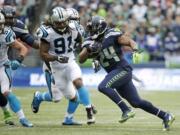 Seattle Seahawks running back Marshawn Lynch rushes against Carolina Panthers' Ryan Delaire (91) in the second half of an NFL football game, Sunday, Oct. 18, 2015, in Seattle.