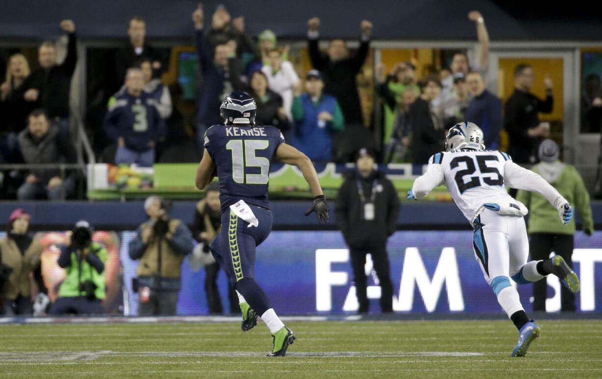 Seattle's Jermaine Kearse (15) runs past Carolina cornerback Bene Benwikere on his 63-yard scoring play.