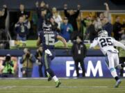 Seattle's Jermaine Kearse (15) runs past Carolina cornerback Bene Benwikere on his 63-yard scoring play.