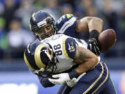 Associated Press files
Seattle linebacker Bobby Wagner, right, strips the ball from St. Louis tight end Lance Kendricks (88) during a Dec. 28 game. The play was an example of the ferocity that Wagner and Carolina's Luke Kuechly are known for, a playing style that clashes with their personalities off the field. The teams play Saturday in Seattle.