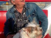 John Ferris rides with his adopted dog, Ginger, on a ferry to Peaks Island, Maine.