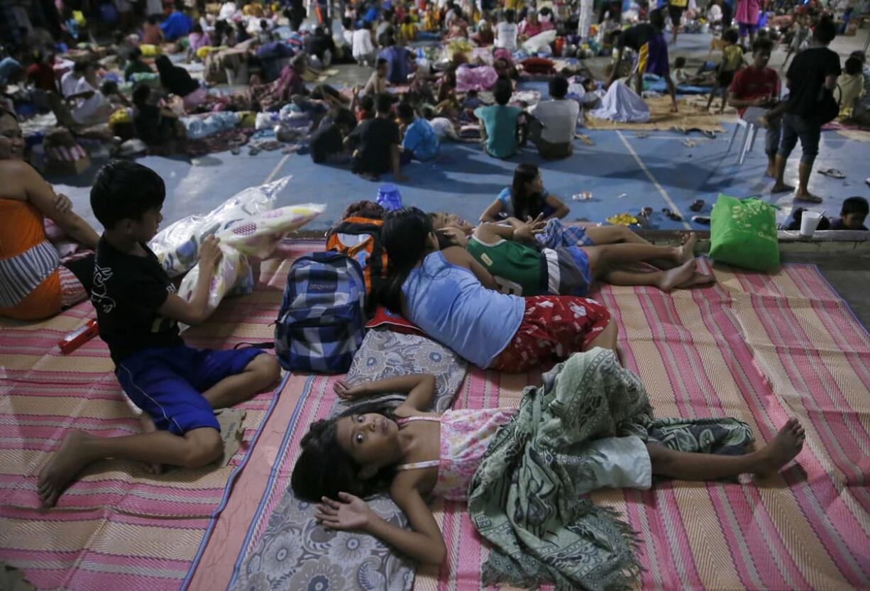 Typhoon evacuees are housed at a school gymnasium after fleeing their homes due to flooding brought by Typhoon Koppu in Cabanatuan city in northern Philippines on Monday.