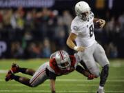 Oregon's Marcus Mariota (8) runs past Ohio State's Eli Apple (13) during the first half of the NCAA college football playoff championship game Monday, Jan. 12, 2015, in Arlington, Texas.