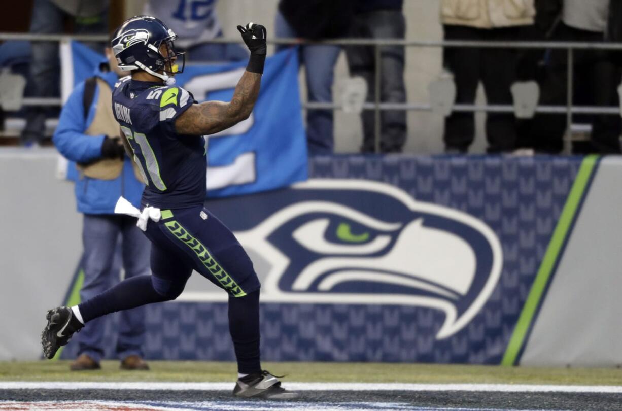 Seattle Seahawks linebacker Bruce Irvin scores a touchdown after making an interception against the St. Louis Rams in the second half of an NFL football game, Sunday, Dec.