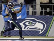 Seattle Seahawks linebacker Bruce Irvin scores a touchdown after making an interception against the St. Louis Rams in the second half of an NFL football game, Sunday, Dec.