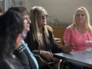 Kimberly Quigley, center, longtime Red Lion Hotel Vancouver at the Quay banquet captain, shares her feelings about the Spokane-based chain&#039;s decision not to offer severance to part-time employees who will lose their jobs after the hotel complex closes at day&#039;s end on Oct. 31. Fellow employee Cyndee Ball, right, looks on at Torque Coffee.