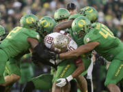 Florida State wide receiver Rashad Greene gets tackled by Oregon defenders during the second half of the Rose Bowl playoff semifinal, Thursday, Jan. 1, 2015 in Pasadena, Calif. (AP Photo/Jae C.