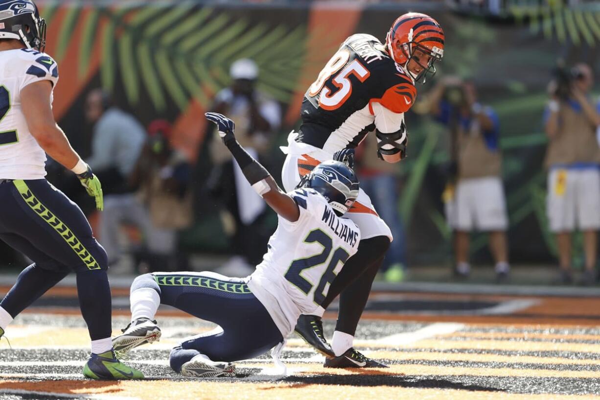 Cincinnati Bengals tight end Tyler Eifert (85) scores a touchdown against Seattle Seahawks cornerback Cary Williams (26) in the second half of an NFL football game, Sunday, Oct. 11, 2015, in Cincinnati.